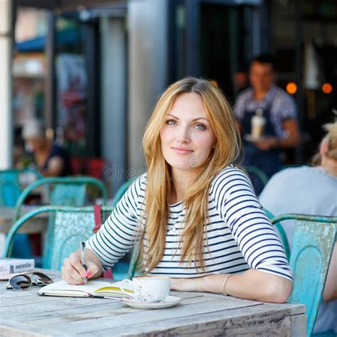 Woman Drinking Coffee And Writing Notes In Cafe Stock Image Image Of