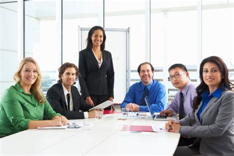 Businesswoman Conducting Meeting In Boardroom Stock Photo Download