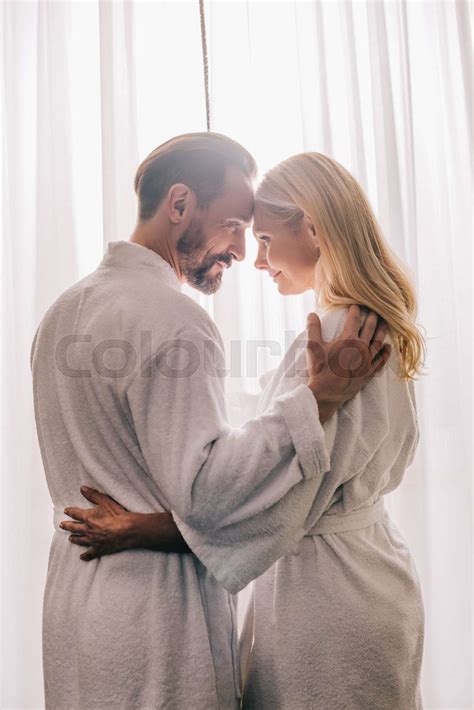 mature couple in bathrobes hugging stock image colourbox