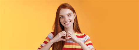 lovely friendly looking charismatic smiling redhead girl express affection love and friendship