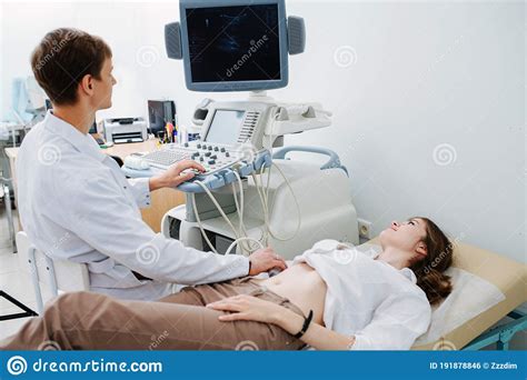 Us Specialist Performing Ultrasound Scan On A Young Female Patient