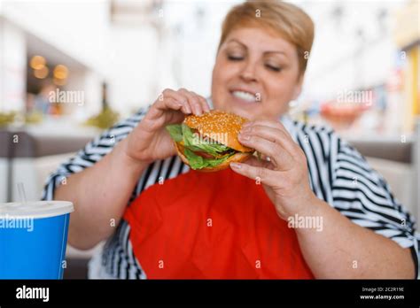 Fat Woman Eating Fastfood In Mall Food Court Overweight Female Person At The Table With Junk