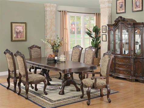 An open dining area with an oval dining table surrounded with white wingback chairs over a camo rug. Simple and Formal Dining Room Sets - Amaza Design