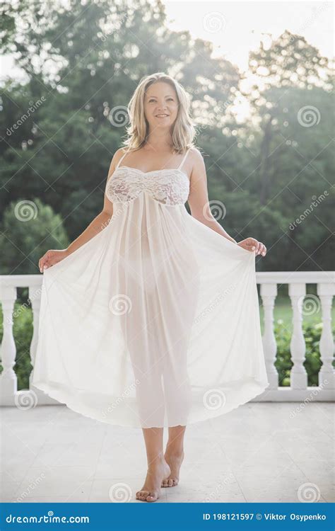 Blonde Woman In A Nightgown Came Out On The Porch At Dawn Stock Image 198121597