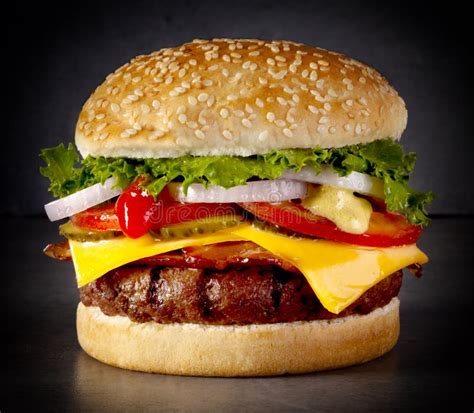 Big Burger With Lettuce Onion Tomato Cheese And Pickles Stock Photo