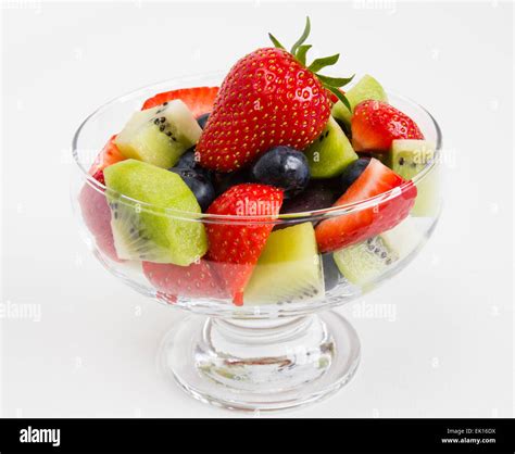 Fresh Mixed Fruit Salad In A Glass Bowl Isolated On A White Background