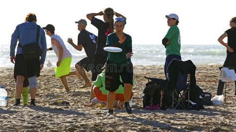 Playing The Frisbee On The Beach Of Castelldefels Editorial Photo