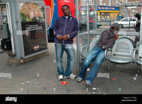 Two Black Youths Linger At A Bus Stop In Londons Inner City They Are Happy To Pose In Wood