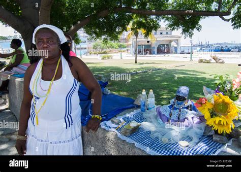 havana cuba santeria woman in white with doll with african religion and catholic in habana 17