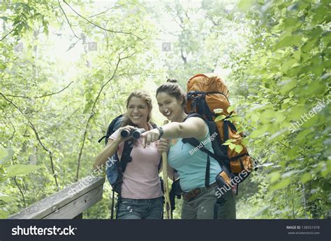 Young Women Hiking Together In A Forest Stock Photo 138551978