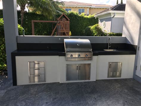 This is a large modern kitchen with stainless steel appliances iset into a long island bench and. Modern Luxury Outdoors - The BBQ Depot
