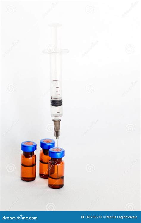 Medical Vials Ampules For Injection With A Syringe On A White