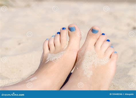 Closeup On Woman Sandy Feet With Blue Nails Pedicure Stock Photo