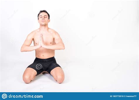 Shirtless Athlete Man Kneeling On The Floor Taking Deep Breaths To