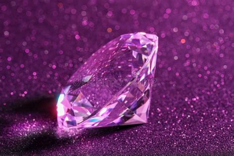 Beautiful Shiny Diamond On Purple Glitter Background Closeup Stock