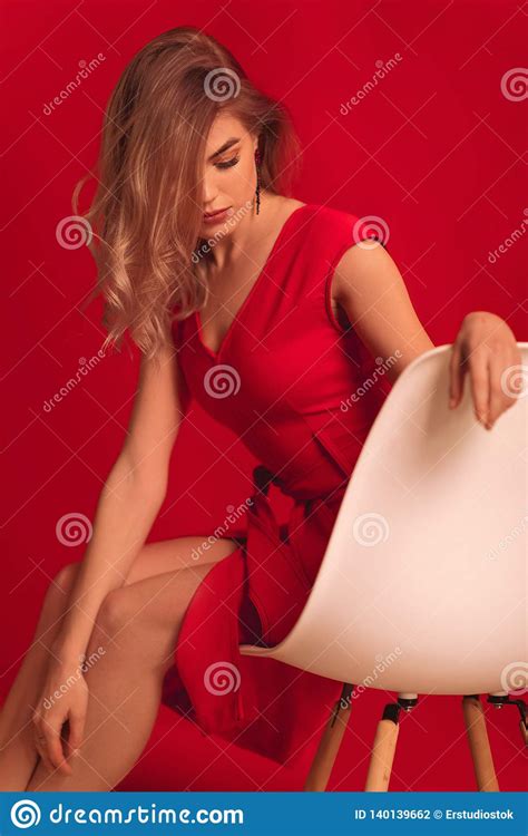 Blonde Woman Posing In Red Dress On Red Background Stock Photo Image