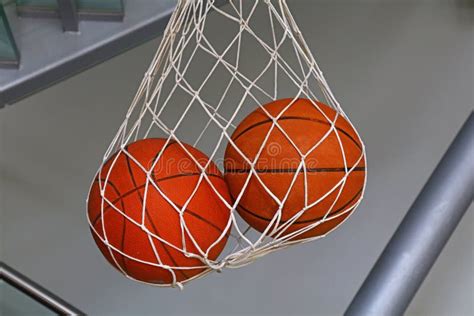 Two Basketball Balls Hanging In Mesh Sack Stock Image Image Of Mesh