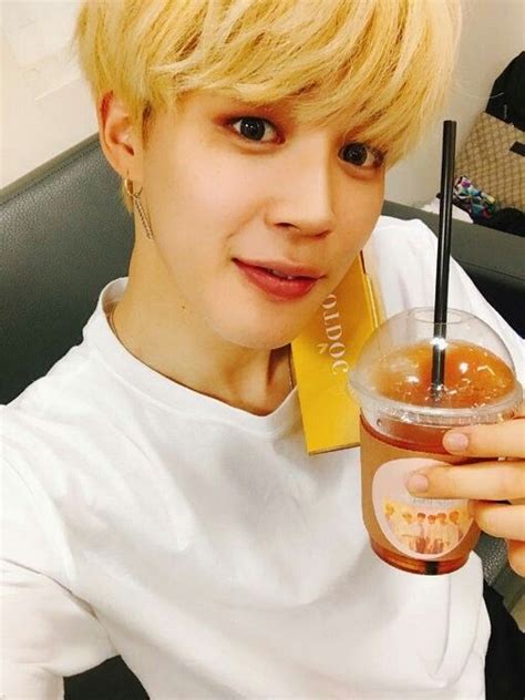A Person With Blonde Hair Holding A Drink