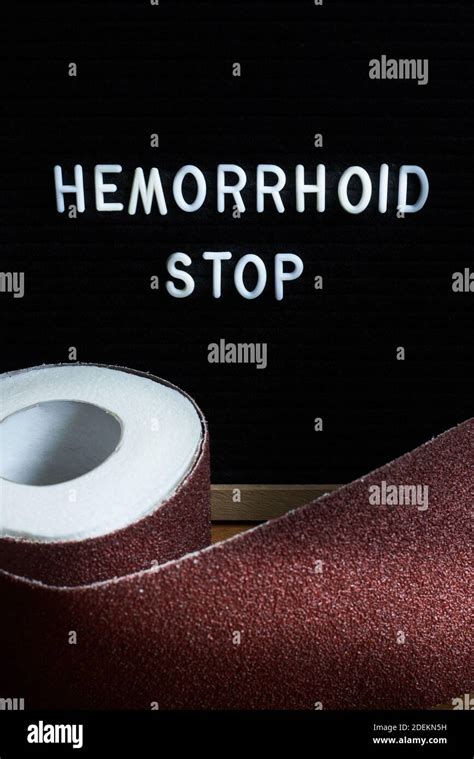 Words Hemorrhoids Stop And A Roll Of Toilet Paper Wrapped In Sandpaper