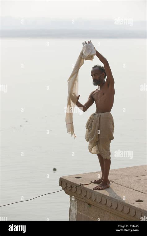 pilgrim airing a dhoti on the ghats lining the river ganges varanasi uttar pradesh india