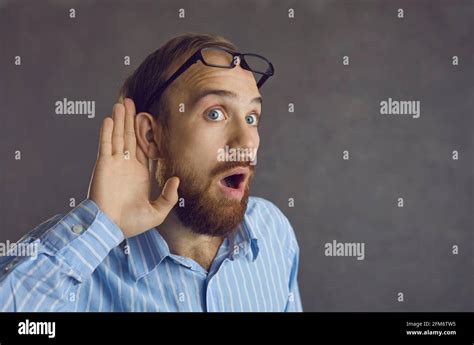 Curious Man Listening With Hand At Ear Eavesdropping On A Shocking