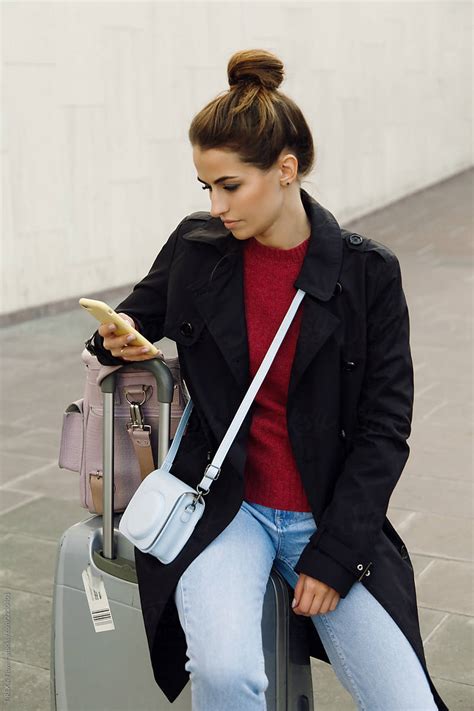 Female Traveler Using Smartphone By Danil Nevsky