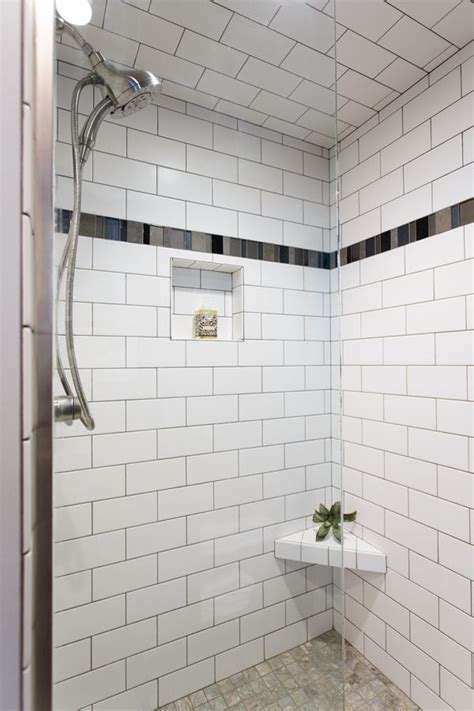 White Subway Tile Shower With Accent Floor And Dark Tile Accent Strip Shower Tile Bathroom