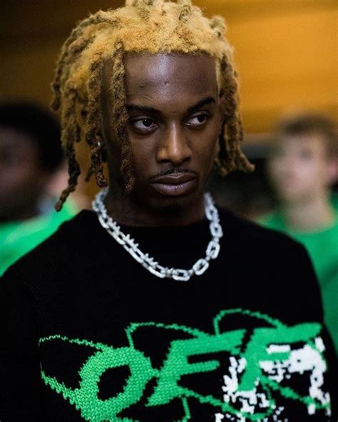 A Man With Dreadlocks On His Head And Wearing A Black T Shirt