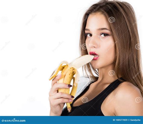 Young Beautiful Woman Eating Banana On White Background Stock Image