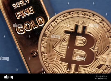 Bitcoin Cryptocurrency Coin With A Gold Bullion Bar Investment Concept