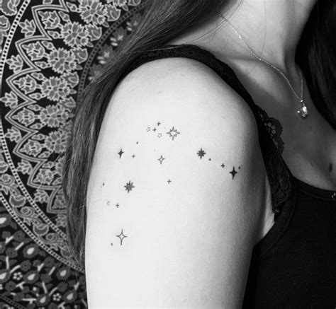 A Woman With A Star Tattoo On Her Arm
