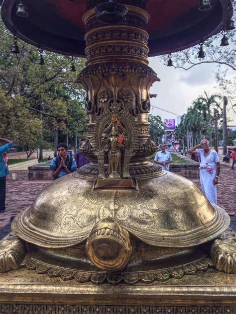 Statue Of Vishnu Kurma Avatar At The Base Of Oil Lamp Tower