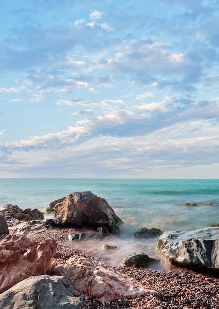 Premium Photo Sea Stones Pebbles Sky With Clouds