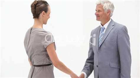 Business People Shaking Hands Against A White Background Lizenzfreie