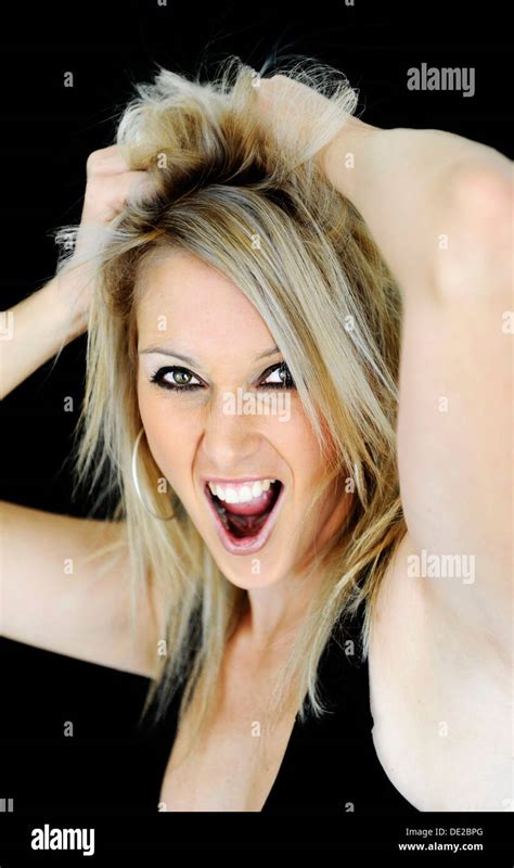 Blonde Young Woman Grabbing Her Hair And Screaming Portrait Stock