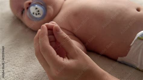 Vid O Stock Health Skin Care Development Pediatrics Infant Close Up Mother Hands Give Naked