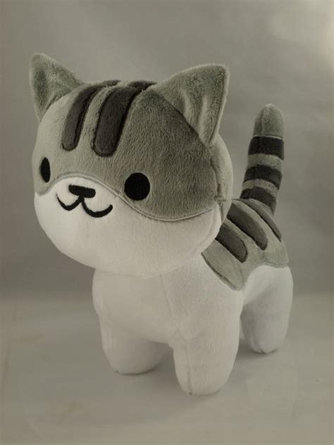 A Gray And White Cat Stuffed Animal With Black Stripes