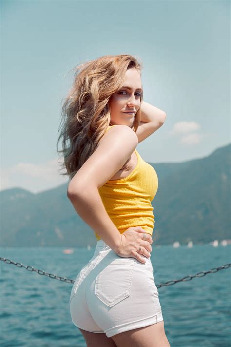 Beautiful Blonde Woman Posing In A Yellow Top Wearing White Shorts On