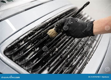 Car Wash Worker Carefully Cleaning Car With Special Brush Stock Photo
