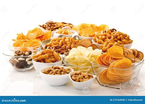 Assorted Dry Snacks On A Wooden Board Chips Peanuts Croutons Wasabi