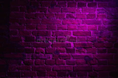 Old Brick Wall With Violet Neon Glow Effect As Background Texture Stock