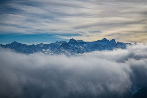 Snowy Mountains Hiding Behind The Clouds As Seen From Fronalpstock Peak