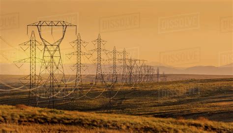 Electrical Power Lines Through A Rural Landscape At Sunset Usa Stock