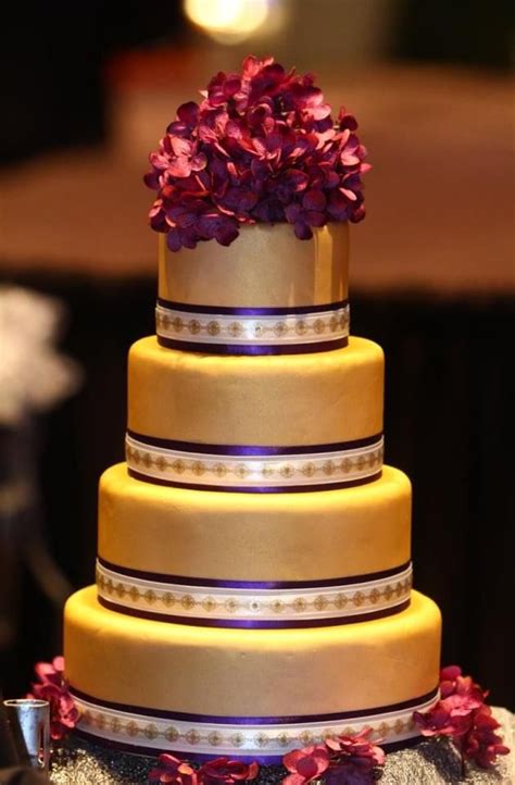 Stunning Purple And Gold Wedding Cake Covered With Fondant Icing
