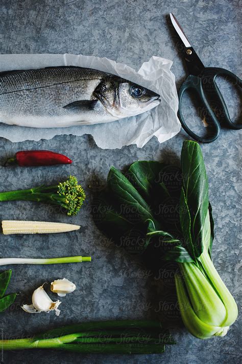 Sea Bass And Ingredients For Cooking By Stocksy Contributor Darren Muir Stocksy