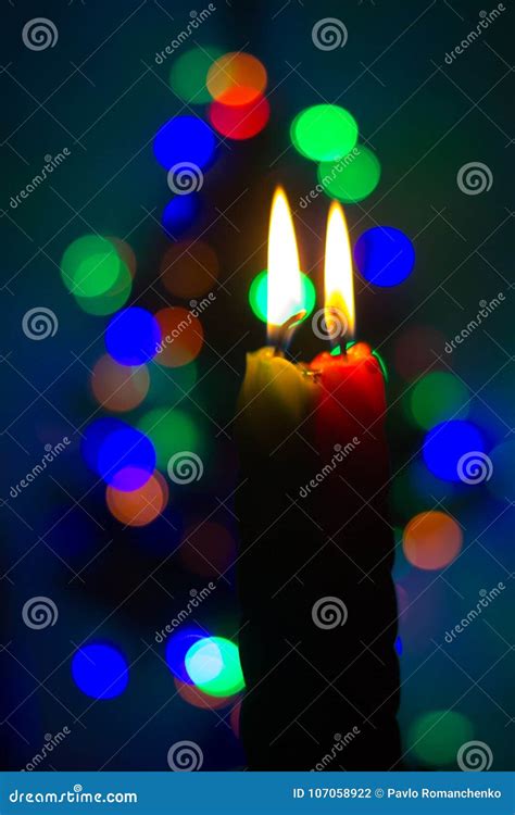 Two Burning Candles On A Colored Decoration Blurred Background Stock