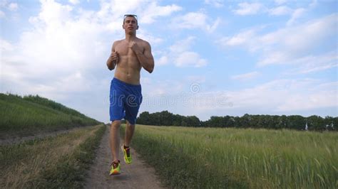 Two Muscular Men Running Outdoors Young Athletic Guys Jogging Over The