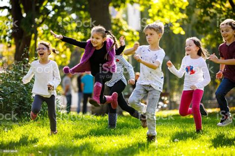 Happy Children Running Outside Stock Photo Download Image Now Istock