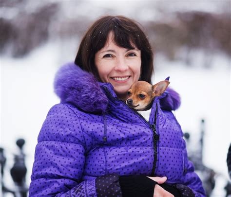 premium photo portrait of smiling woman with russian toy in arms