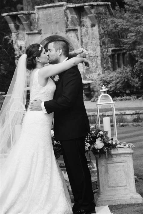 Bride And Groom Sharing Their First Kiss In Front Of An Amazing